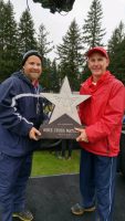 Doug Soles (left) and Dan Noble raise the 2015 Nike Cross Nationals (NXN) championship trophy.