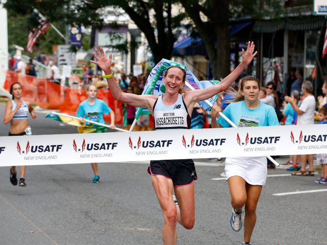 Women's winner Kim Nedeau crosses the finish line with time of 29:31 during the 41st Bridge of Flowers Road Race Classic on Saturday morning in Shelburne Falls.